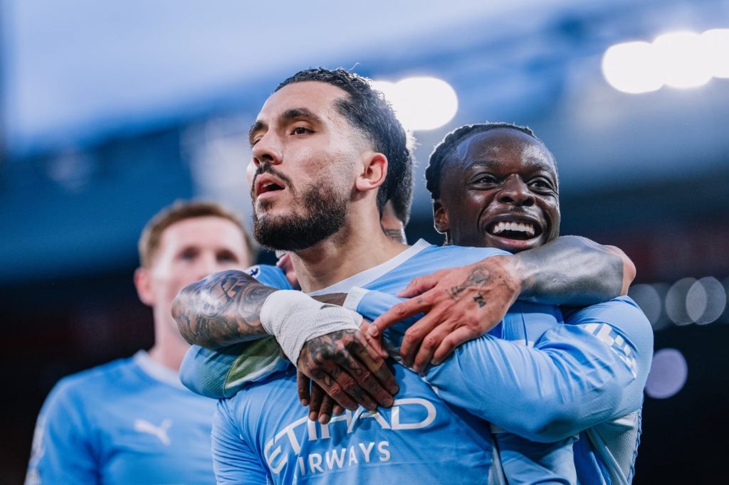 Manchester City players celebrate during their Premier League fixture against Liverpool at Anfield.