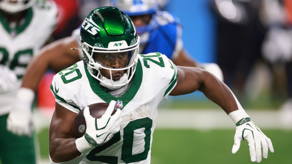 Jets running back Breece Hall on the sidelines during a game.