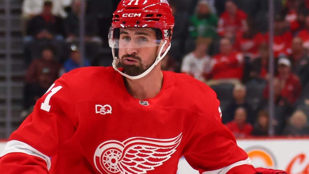 Dylan Larkin and Darcy Kuemper in their respective NHL team uniforms.